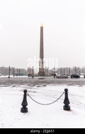 Place de la Concorde Obelisk in Paris during winter with snow in a cloudy day Stock Photo