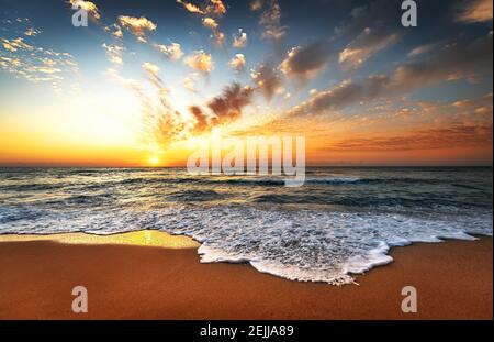 Sunset sea waves sky clouds landscape. Stock Photo