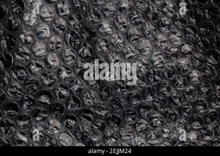 dark air bubble wrap - real life close-up flat texture and background Stock Photo