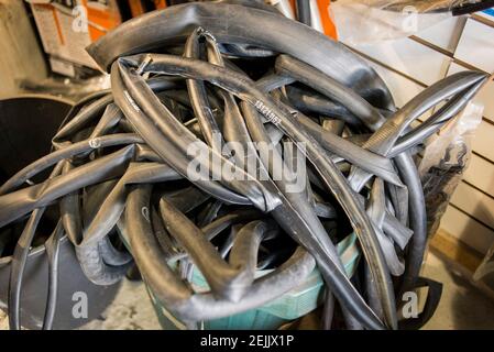 A pile of old bicycle inner tubes worn and stored read to be repurposed or recycled Stock Photo Alamy