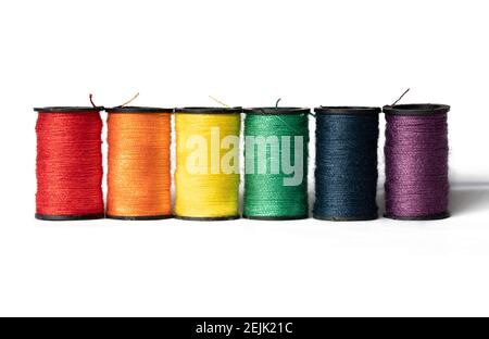 Spools of thread in colors of the rainbow on white background Stock Photo