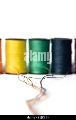 Thread spools on blue background Stock Photo - Alamy