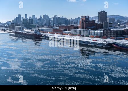 MONTREAL, CA - 22 February 2021: View of Montreal Skyline and frozen Saint-Lawrence River from Jacques Cartier Bridge Stock Photo