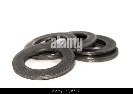 A few big industrial galvanized steel washers on white background Stock Photo