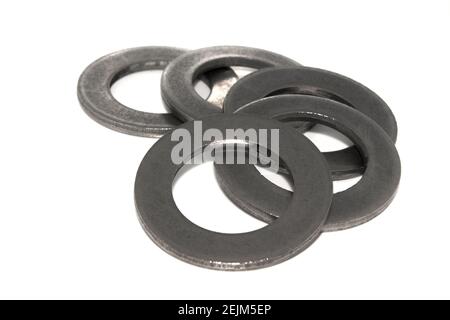 A few big industrial galvanized steel washers on white background Stock Photo