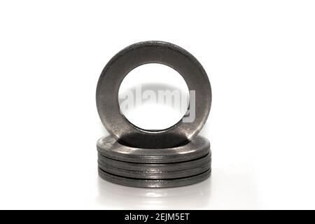 A few big industrial galvanized steel washers on white background Stock Photo