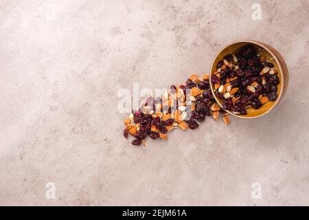 View of a bowl with almonds and blueberries, they fall out of the bowl on the table a very artistic view with room for text. Nuts collection in wooden Stock Photo