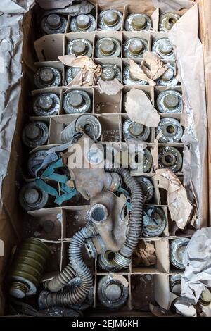 Gas masks on the floor in the middle school in Pripyat, Chernobyl region, Ukraine in a summer day Stock Photo