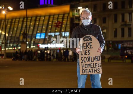 Glasgow, Scotland, UK. 22nd Feb, 2021. Pictured: Sean Clerkin - Scottish Tenants Organisation, holding a gravestone shaped placard which reads, “HERE LIES SCOTLANDS HOMELESS DEATHS”. Today 23rd Feb 21, the Scottish Government has released the homeless deaths figures 3 days early which are up by an increase of 11% from last year. The link https://www.nrscotland.gov.uk/news/2021/homeless-deaths-2019 shows the article today. Credit: Colin Fisher/Alamy Live News Stock Photo