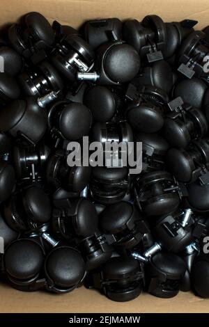 Plastic wheel unit component in cardboard box Stock Photo