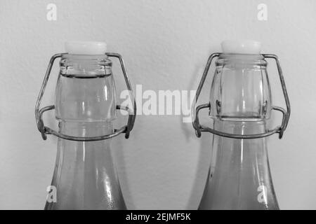 Black and white photo of a row of two glass flip top bottles Stock Photo