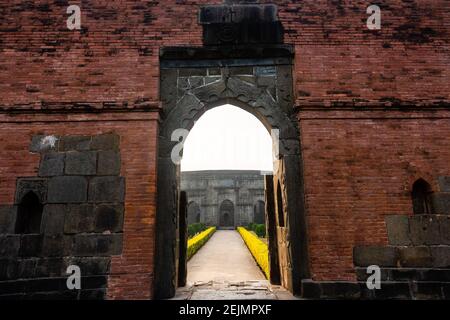 Malda, West Bengal, India - January 2018: The entrance gateway to the ruins of an ancient mosque in the village of Pandua in Malda. Stock Photo