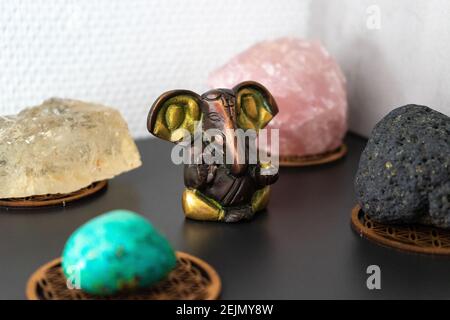 Ganesh statue in the middle of mineral stones inside house. Stock Photo