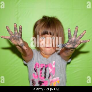 Creative Girl with Paint on her Hands makes a Mess. Green Screen