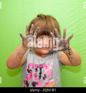 Creative Girl with Paint on her Hands makes a Mess. Green Screen