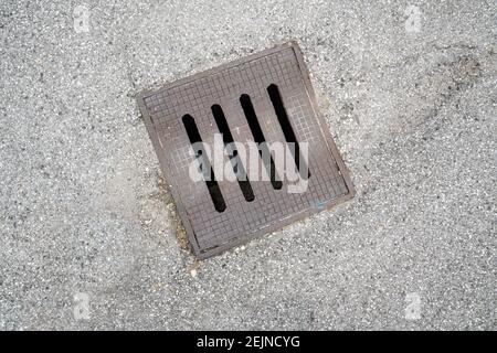 a sewer manhole in the street Stock Photo