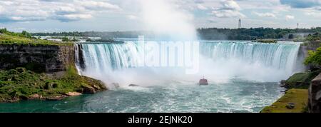 Tourist cruise Ship boat under Rainbow on The Niagara River visiting the Water Falls on a sunny Summer Day Hornblower and Maid of the Mist boats tour Stock Photo