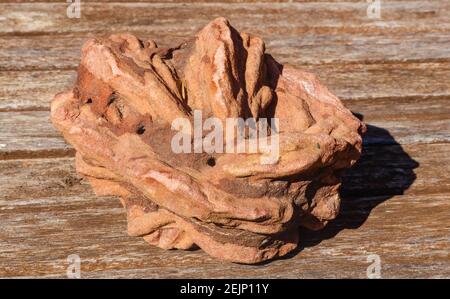 Closeup of rose rock (barite rock crystal - Oklahoma State Rock) sitting on wood Stock Photo