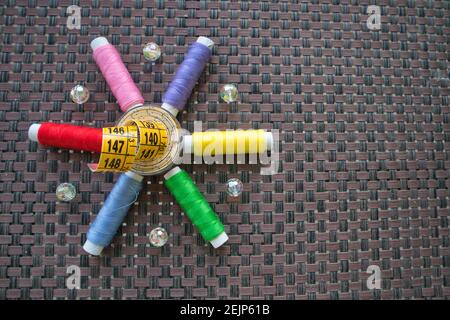 Colorful sewing thread and measuring tape star shape to illustrate home crafts Stock Photo