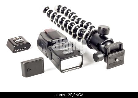 Ready for photography? Black flexible gorillapod tripod, flash, remote trigger. Isolated on white background Stock Photo