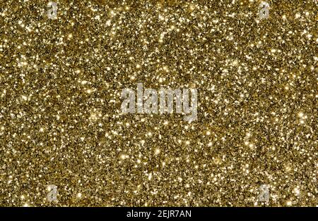 Golden glitter background with sparkles and copy space, one color full frame image. Stock Photo