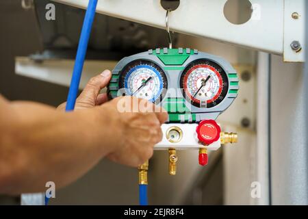 manometers on equipment for investigate and refueling of air conditioners by technician Stock Photo