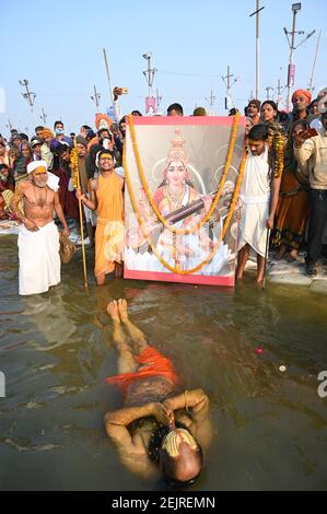 Prayagraj, Uttar Pradesh, India. 16th Feb, 2021. A sadhu or holy man, offers prayers while take holy dip floating in the waters at Sangam on the occasion of Basant Panchami or Spring Festival during the ongoing Magh Mela. Credit: Prabhat Kumar Verma/ZUMA Wire/Alamy Live News Stock Photo