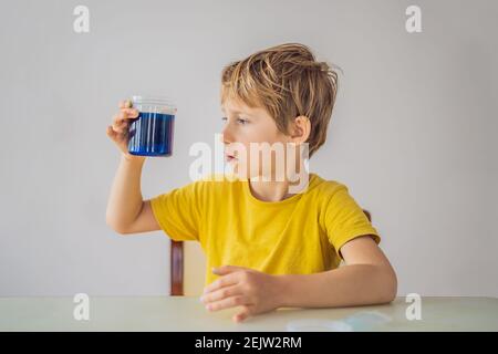 Chemical home tests. Tools for the home lab. the boy Explorer. Child is watching a chemical reaction. The young chemist doing scientific experiments Stock Photo