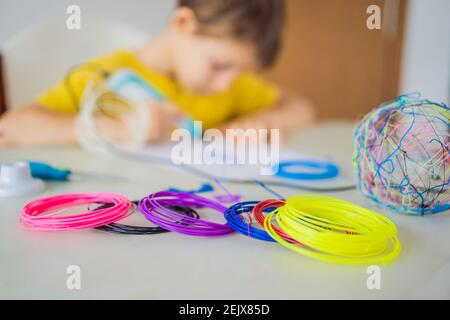 Kid using 3d printing drawing pen. Creative, leisure, technology education concept Stock Photo
