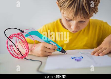 Kid using 3d printing drawing pen. Creative, leisure, technology education concept Stock Photo