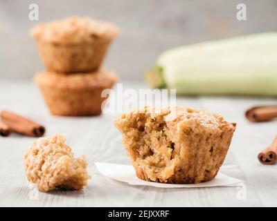 Close up view of muffin with zucchini, carrots, apple and cinnamon on gray wooden background. Sweet vegetables homemade muffins. Toddler-friendly recipe idea. Copy space. Shallow DOF Stock Photo