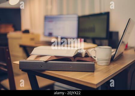 Book, Document file and laptop on workplace at home night. Work at home and  Education at home concept. Stock Photo