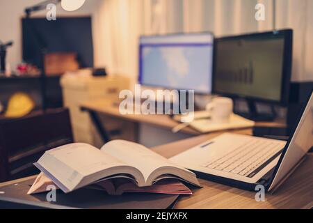 Book, Document file and laptop on workplace at home night. Work at home and  Education at home concept. Stock Photo