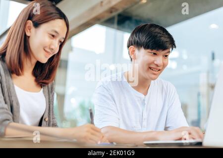 High school or college students  group catching up workbook and learning tutoring on desk and reading, doing homework, lesson practice preparing exam. Stock Photo