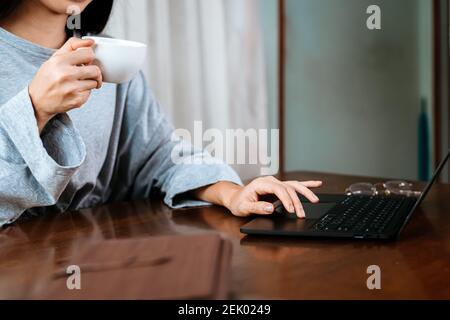 High school or college student learning tutoring on desk and reading, doing homework, lesson practice preparing exam on laptop at home. Stock Photo