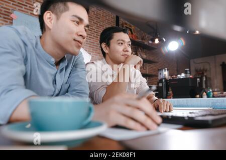 engineers and architect reading building and  drawing outlay construction plan as guide for builders with details on computer. Engineer design and wri Stock Photo