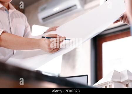 industry manager and engineer, businessman reading and checking blueprint, drawing  in the room Stock Photo