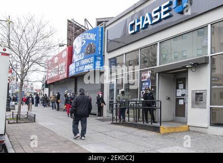 Long line of people waiting to withdraw money seen at Chase Bank 