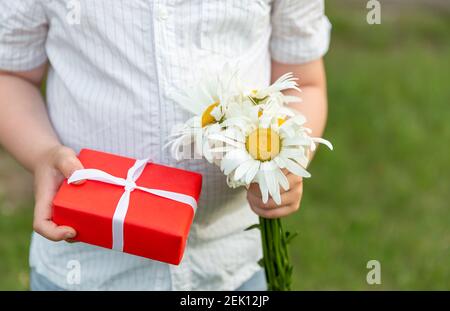 Childrens hands hold gift box. A concept by the Mothers Day. Stock Photo