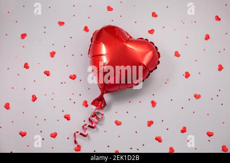 Red Air Balloon of heart shaped foil on festive background. Love concept. Holiday celebration. Valentines Day or wedding Stock Photo