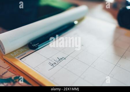 Tourist hold pen and planning vacation with calendar and map. Travel, holiday, vocation and new year concept. Stock Photo