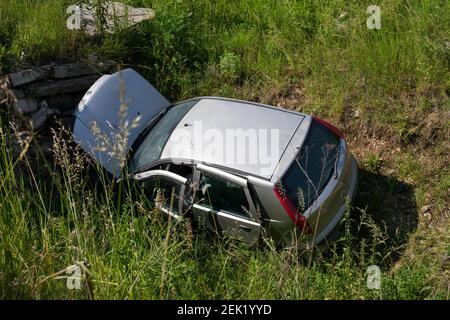 Abandoned smashed car on a country field Stock Photo