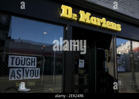 A logo sign outside of a Dr. Martens retail store location in ...