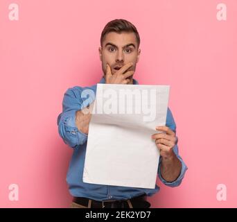 shocked bearded man reading newspaper with fake news, isolated on white ...