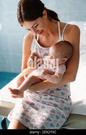 Happy cheerful family. Mother and baby kissing, laughing and hugging Stock Photo