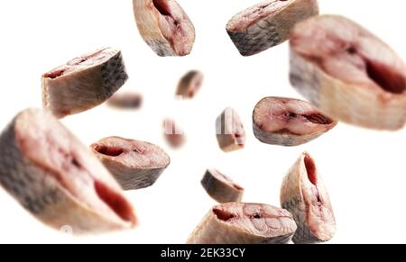 Pieces of fresh fish levitate on a white background Stock Photo