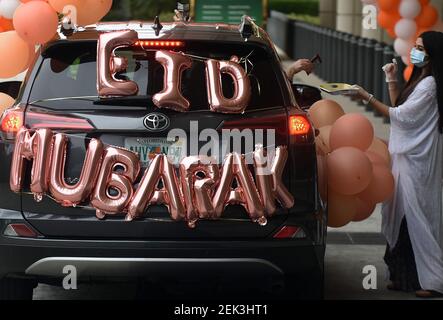 A vehicle decorated with balloons takes part during a car parade