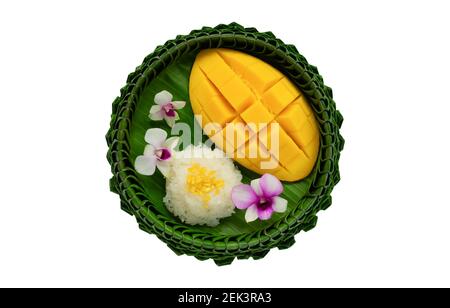 Thai dessert - mango sticky rice on banana leaf plate isolated on white background. Stock Photo