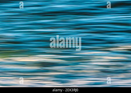Water surface dark blue abstract background, play of ripples, copy space Stock Photo