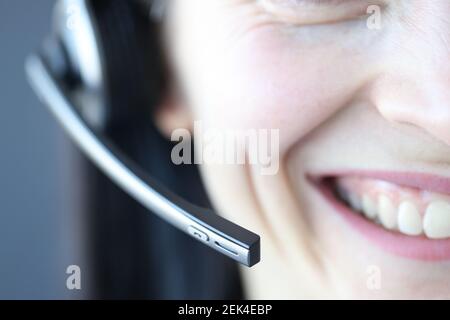 Smiling woman with microphone. Professions for remote work as an operator in call center Stock Photo